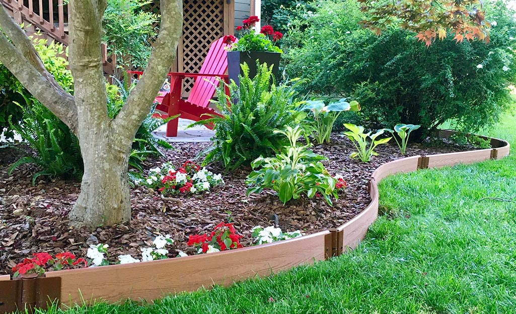 Landscape edging installed between a garden bed and lawn.