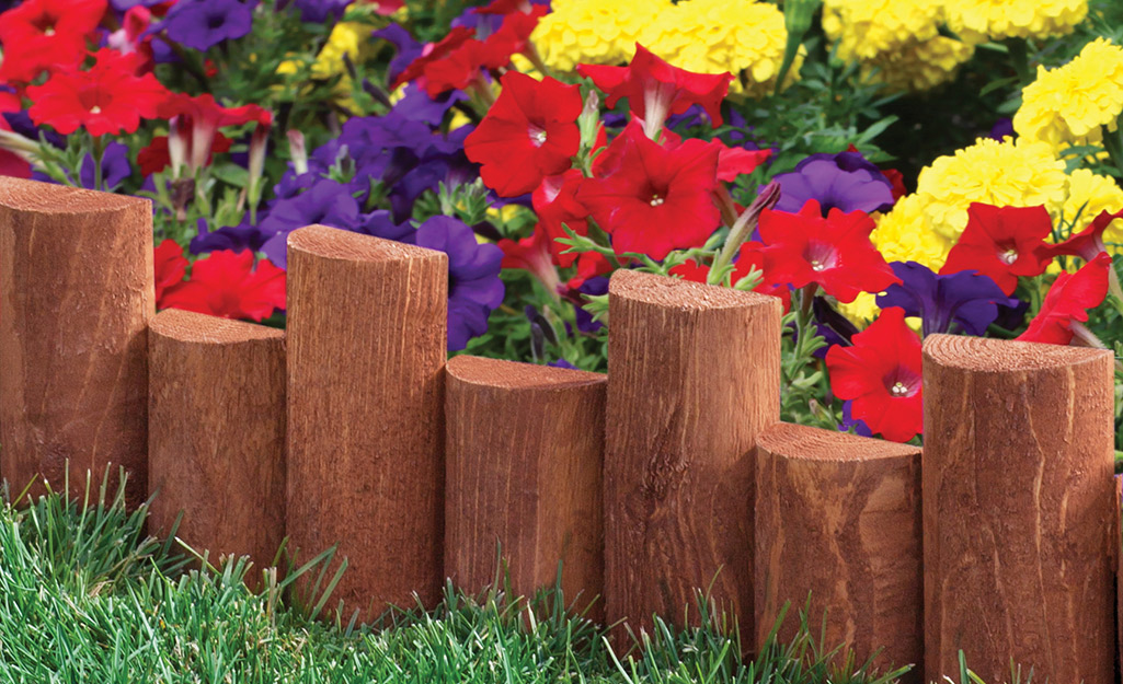 Wood edging installed between a flower bed and lawn.