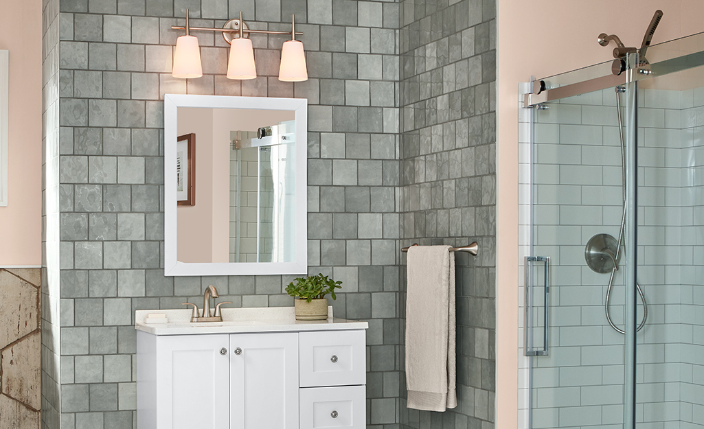 A picture of a vanity mirror with lighting in a bathroom