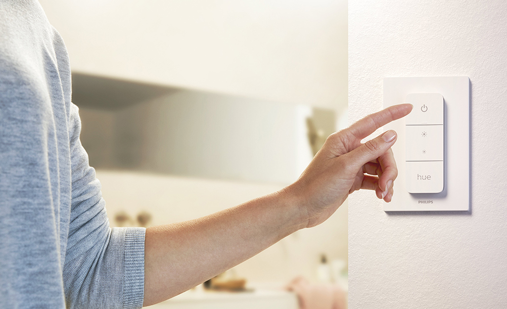 A picture of a light dimmer switch in a bathroom.