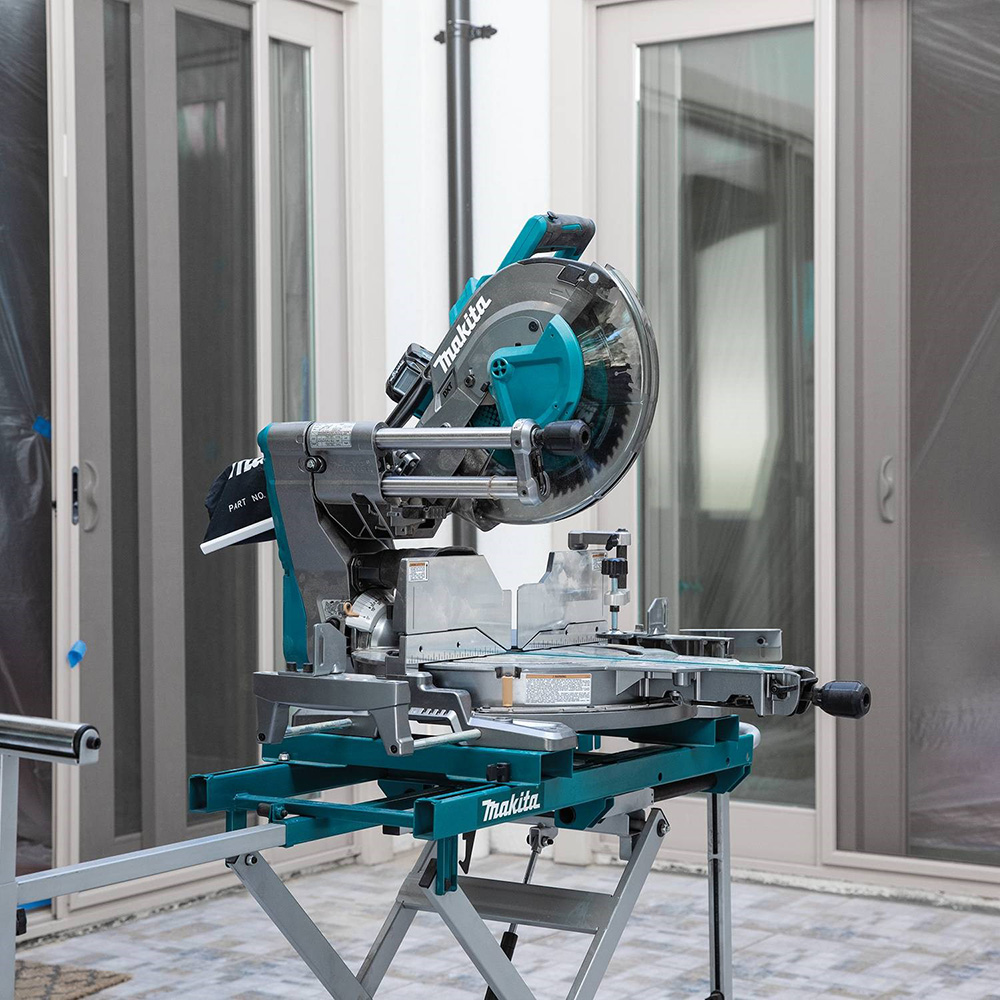 A miter saw on a patio.