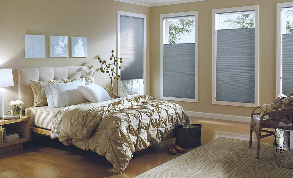 An airy bedroom with top-down bottom-up motorized shades on the windows.