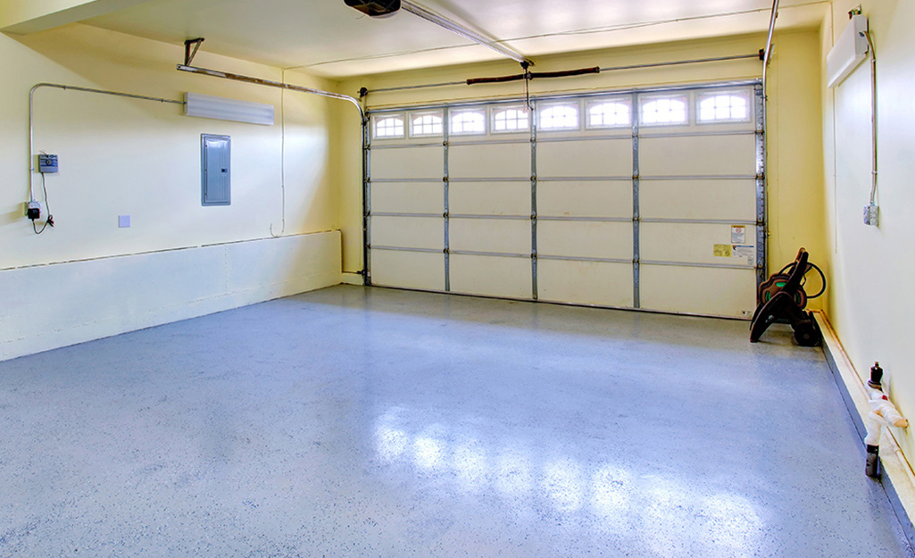A garage featuring a painted concrete floor.