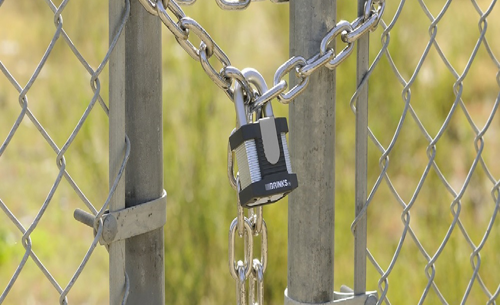 A padlock and chain securing a gate.