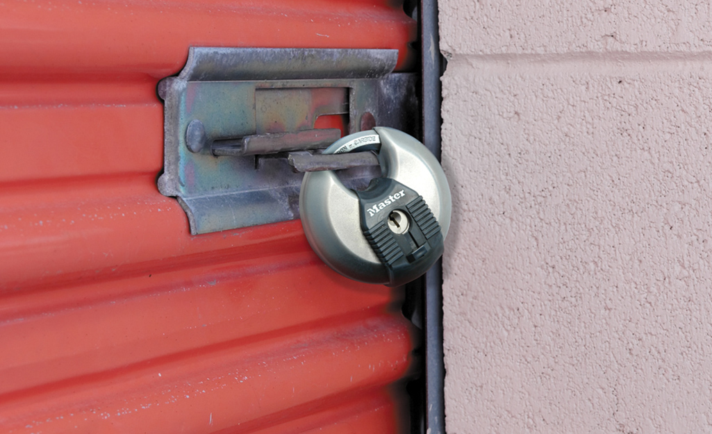 A shrouded lock securing a door at a storage facility.