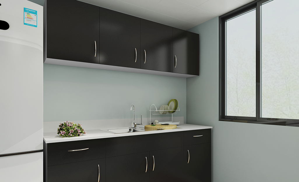 Kitchen cabinets painted black with a high-gloss finish. 