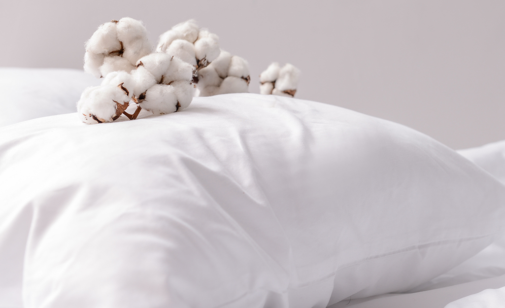A cotton pillow on a bed.