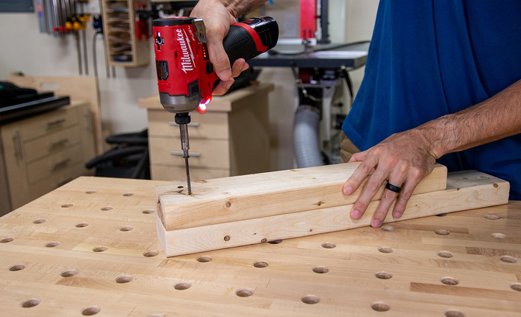 A person using an impact driver.