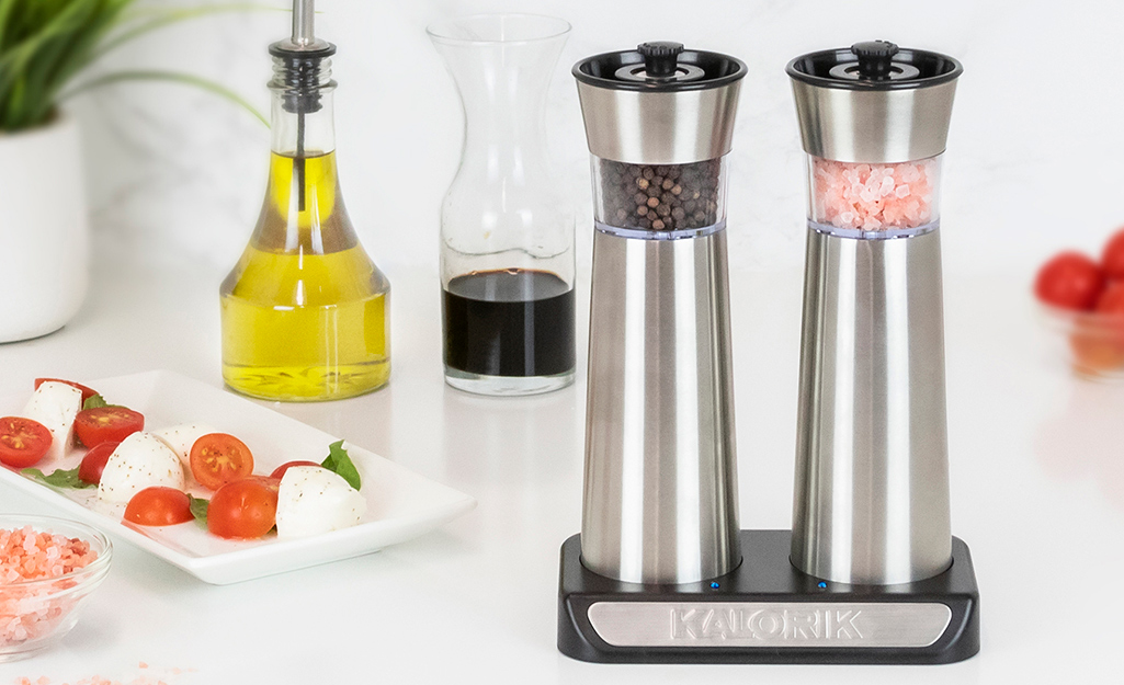 Premium salt and pepper grinders on a counter top.