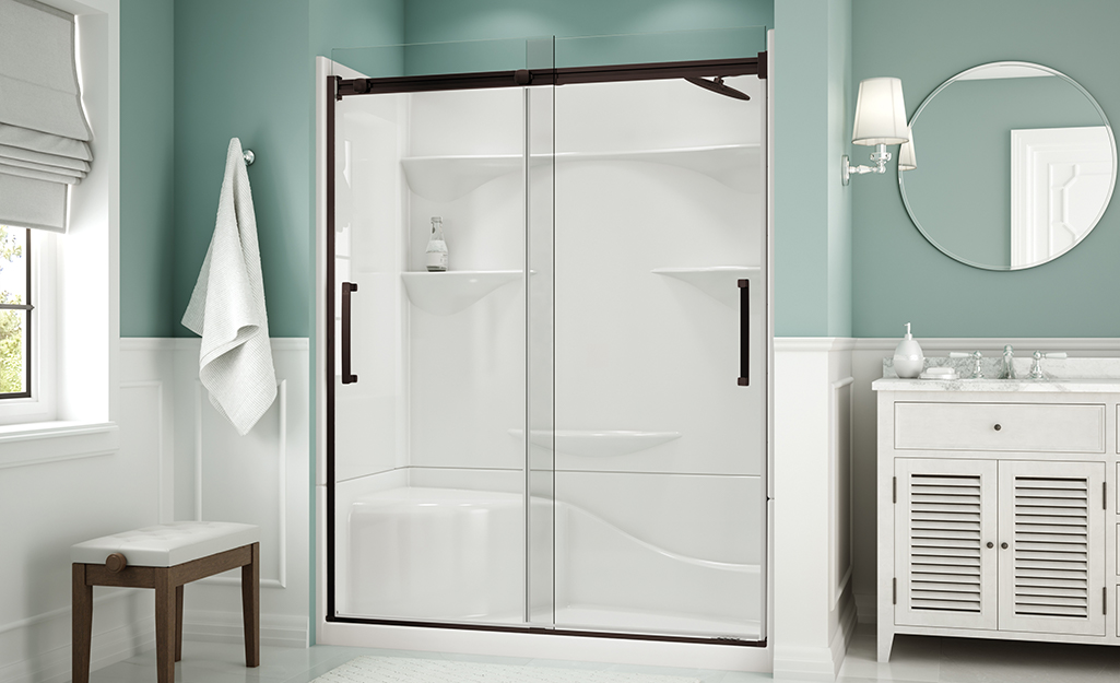 An alcove shower with framed sliding glass doors.