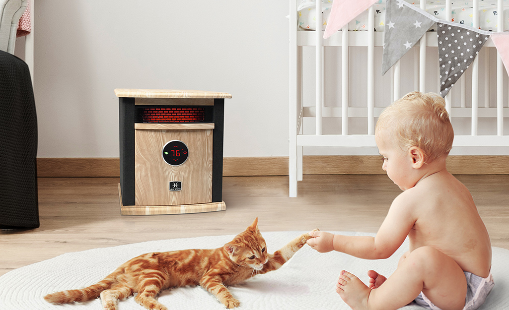 An infrared or reflective heater in a room with a cat and baby.