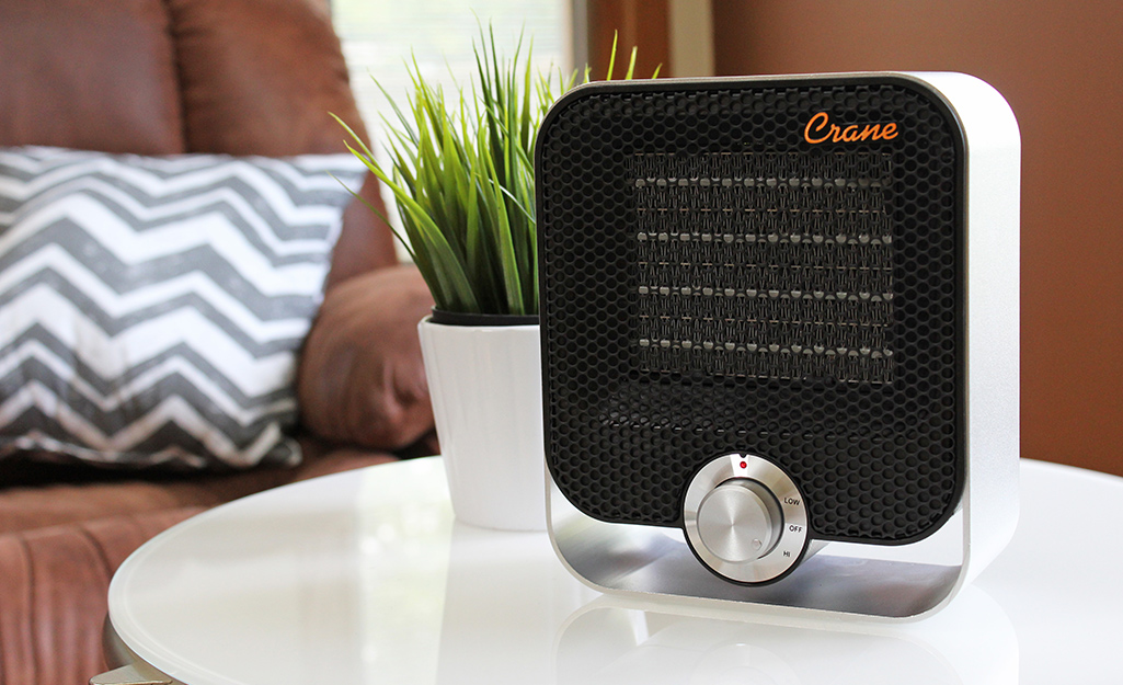 A ceramic heater sits on a side table.