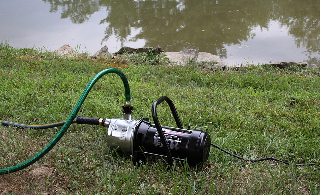 A sprinkler using a pond as their water source.