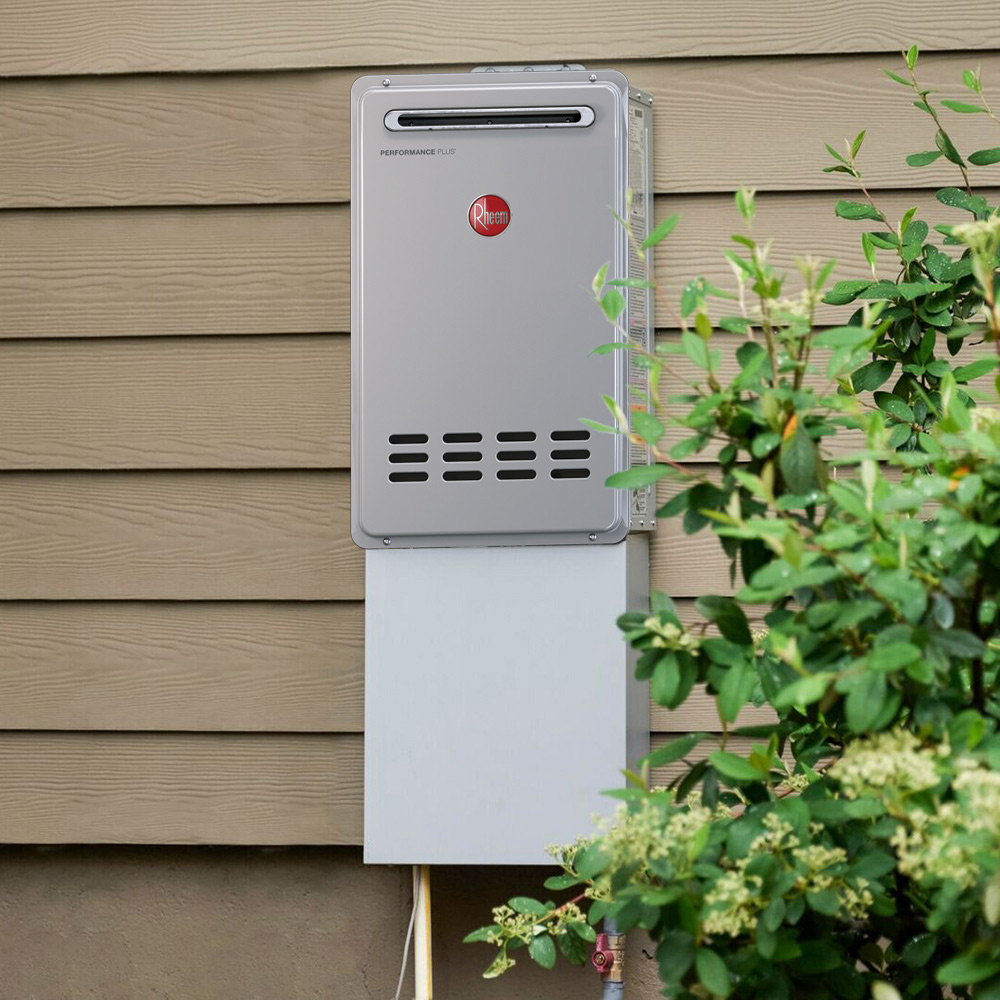 A tankless water heater mounted on the outside of a house.
