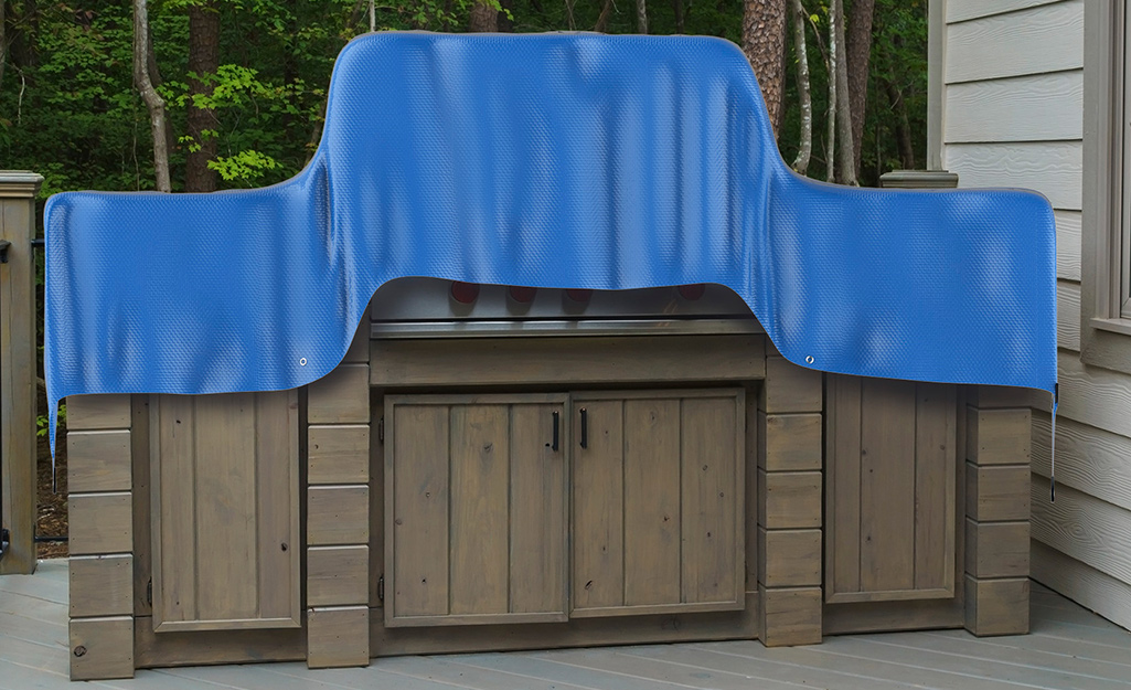 A top with grommets covers a hot tub.