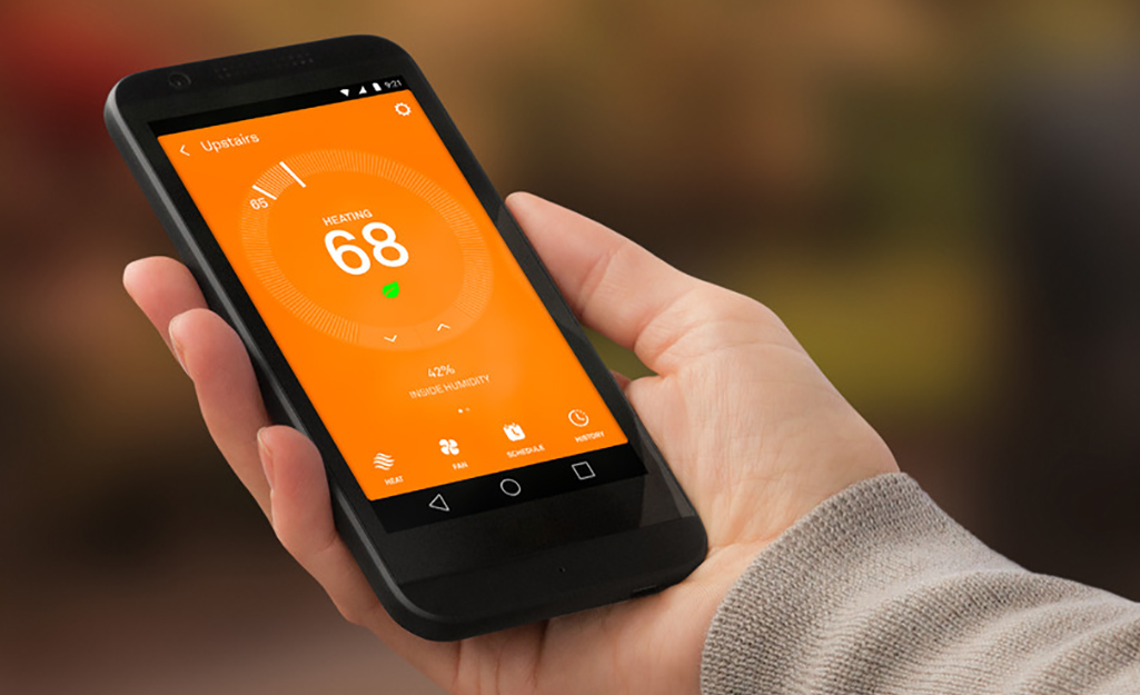 A smartphone showing the interface of an app that controls a smart thermostat.