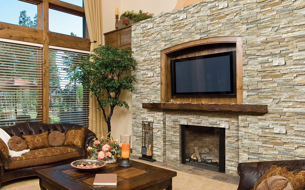 Natural stone surrounding a fireplace in a living room.