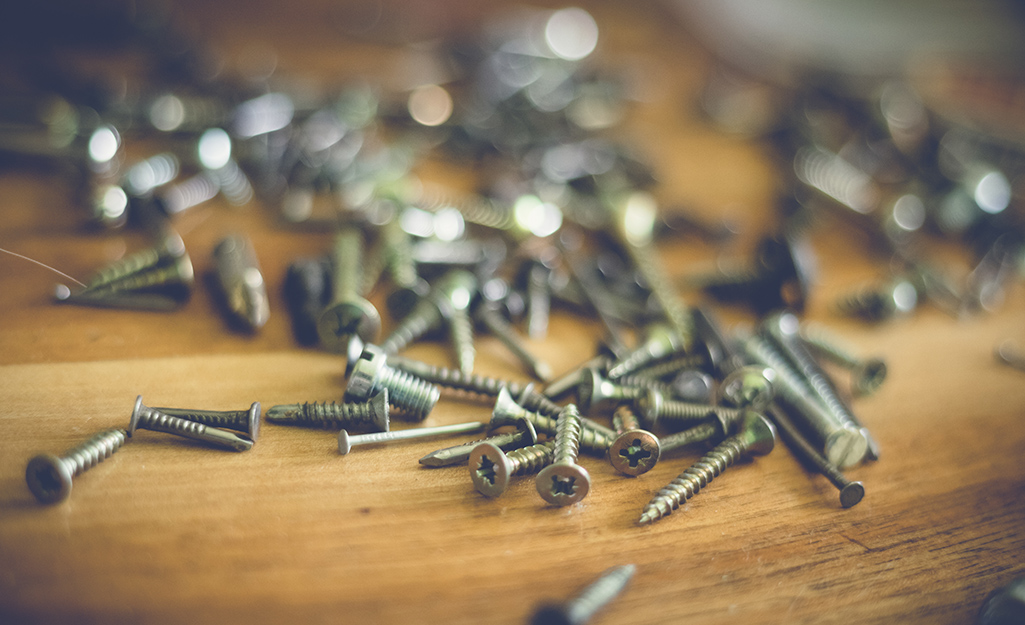 Various nails and screws on a counter. Various nails and screws on a counter.