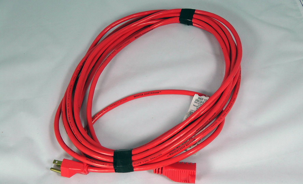 A red extension cord is ready for use. A red extension cord is ready for use.