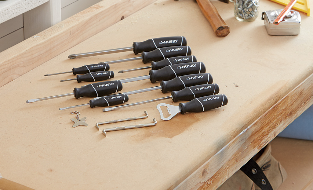 A set of screwdrivers sits on a workbench.