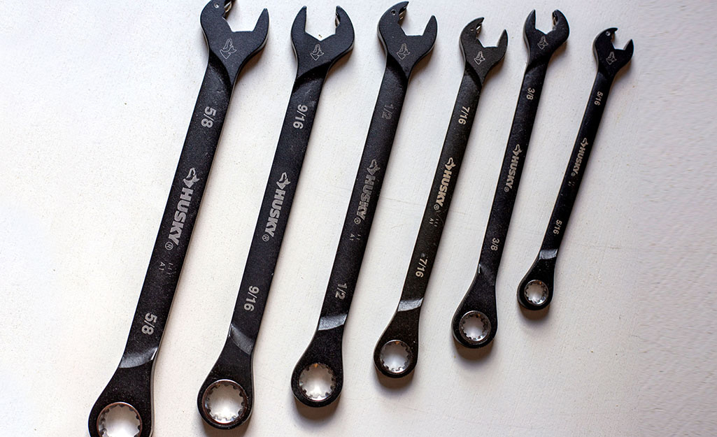 A set of wrenches is displayed on a counter.