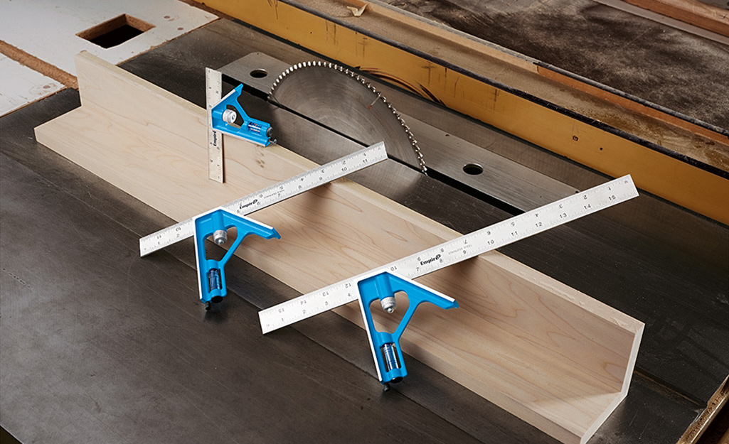 A set of combination squares are used on a woodworking project. A set of combination squares are used on a woodworking project.