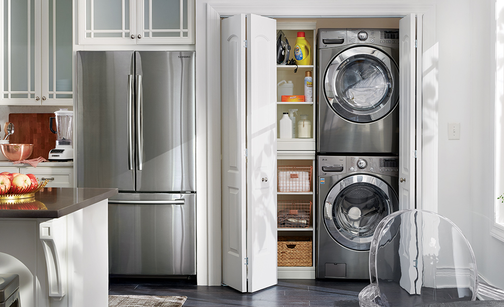 A stacked washer and dryer in a kitchen pantry.