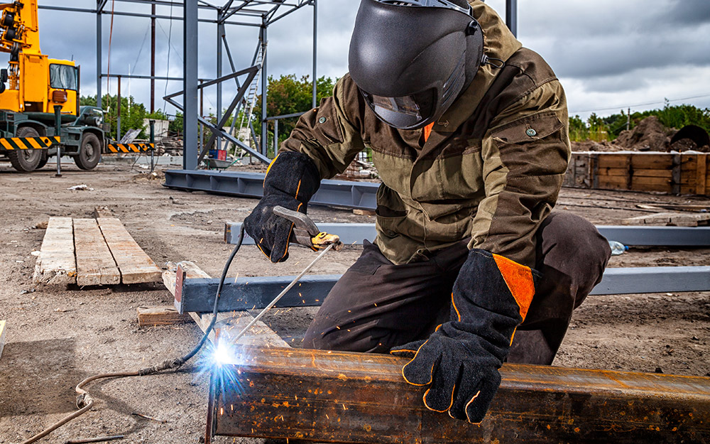 A person wearing a welding helmet while welding