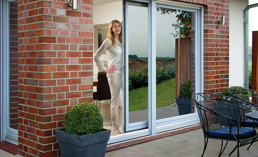 Reflective privacy window film covering two glass sliding doors.