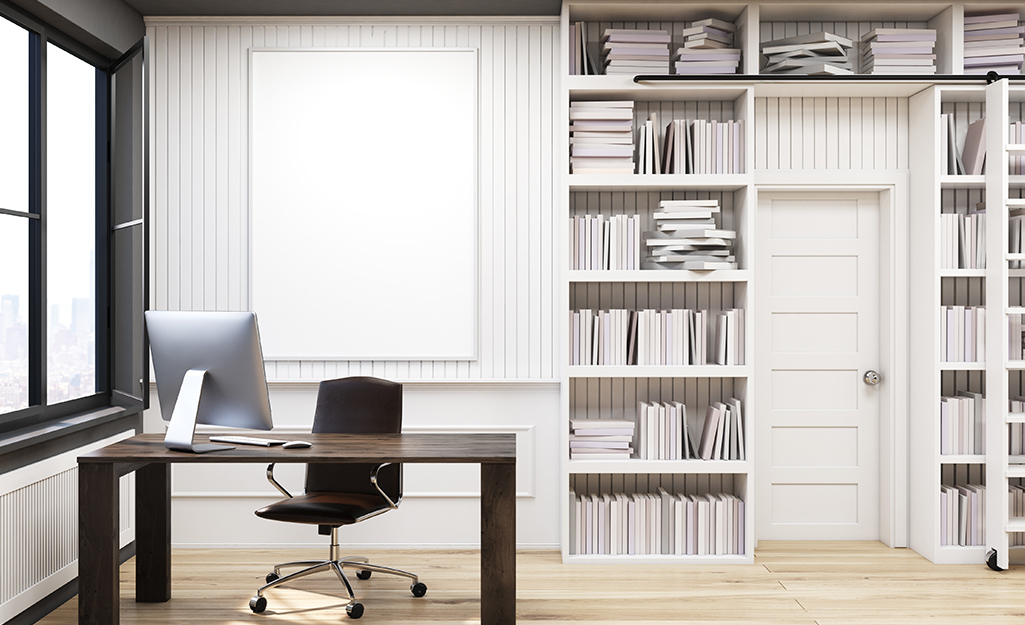 A built-in bookcase frames a doorway in a home office.