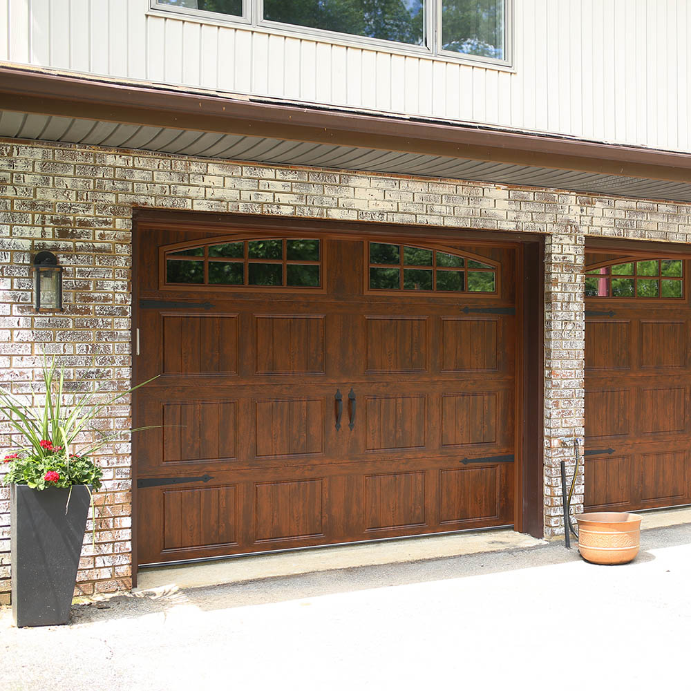 The front of a garage with new wooden garage doors.