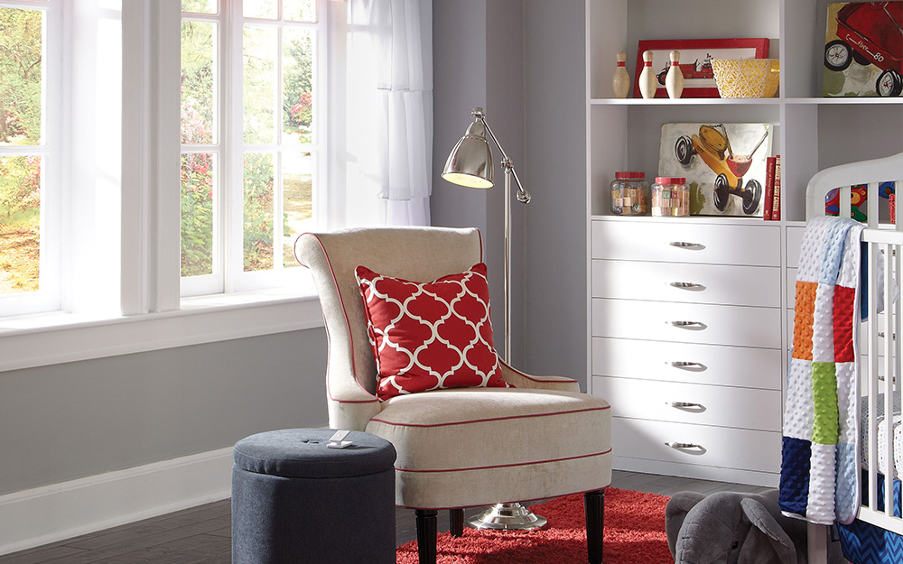 A gray and white boy's nursery with a sports theme.