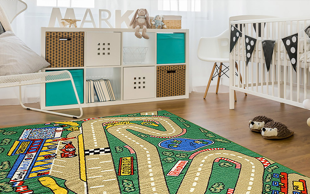 A white boy's nursery with cubbies for storage and a race track themed area rug.