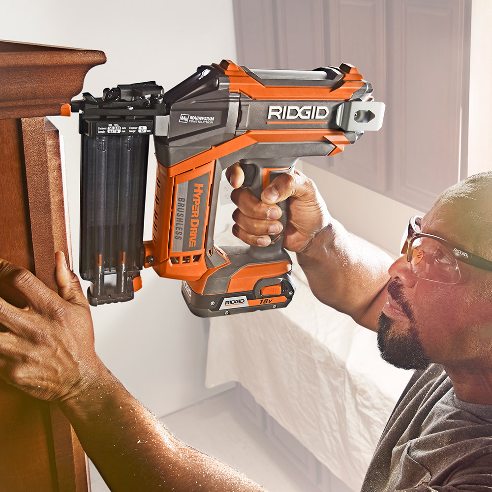 A person using a nailer on a woodworking project.