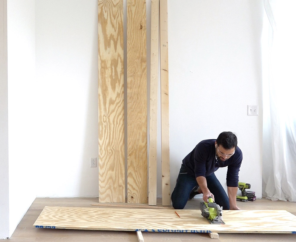 A person cutting plywood 