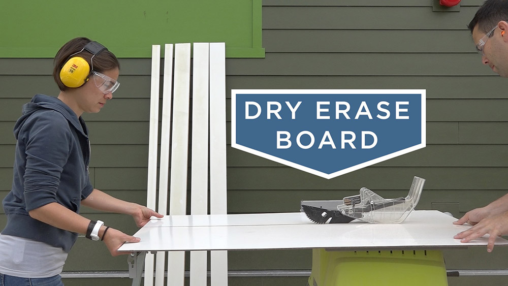 A person cutting dry erase board 