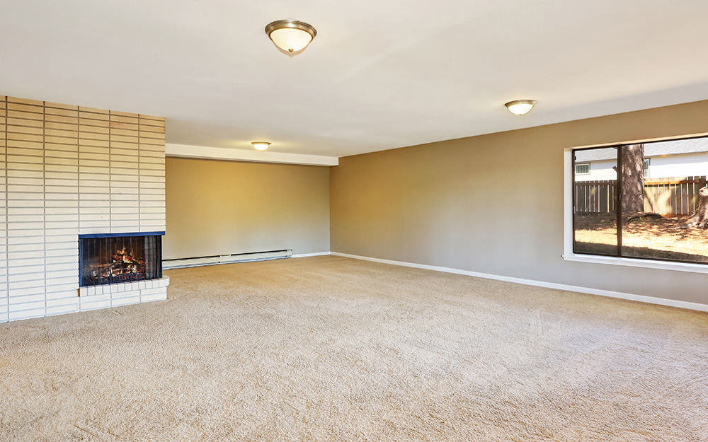 An empty room prepped for newly installed carpet