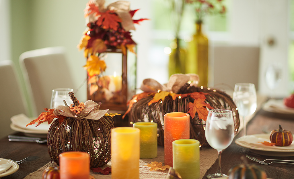 A tablescape with fall-colored candles and arrangements. 