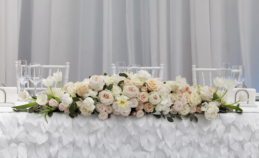 Large floral arrangment on a table.