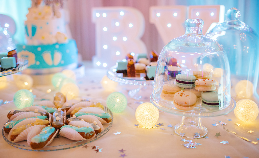 A colorful table with cookies and desserts on top.