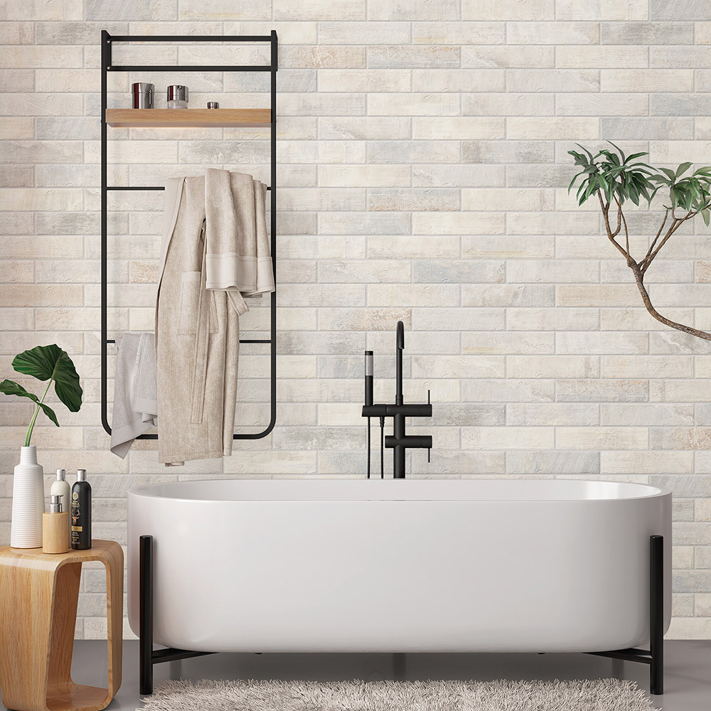 A bathroom with a porcelain tile floor and ceramic tile on the wall.