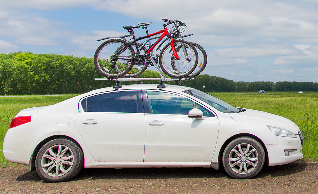 A car features a roof-mounted bike rack.