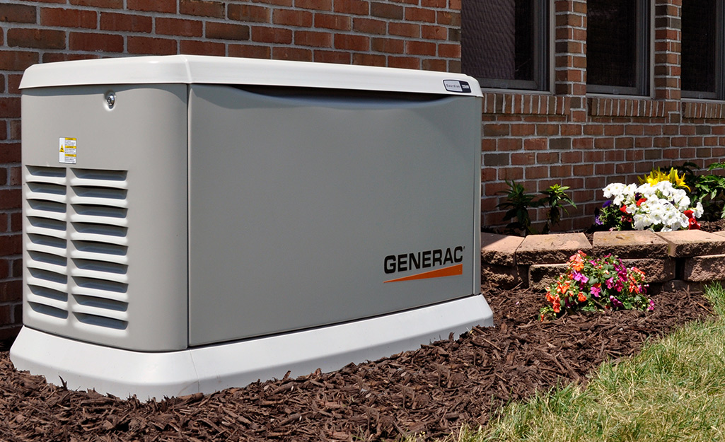 A home standby generator placed next to a brick home.