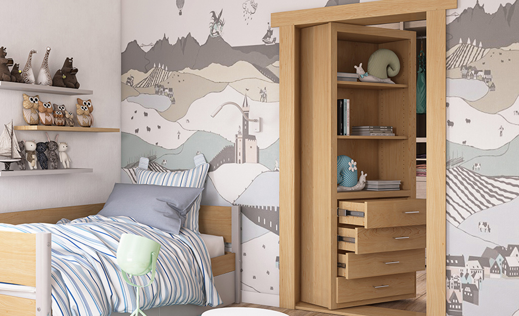 A bookcase door opens into a closet in a child's bedroom.