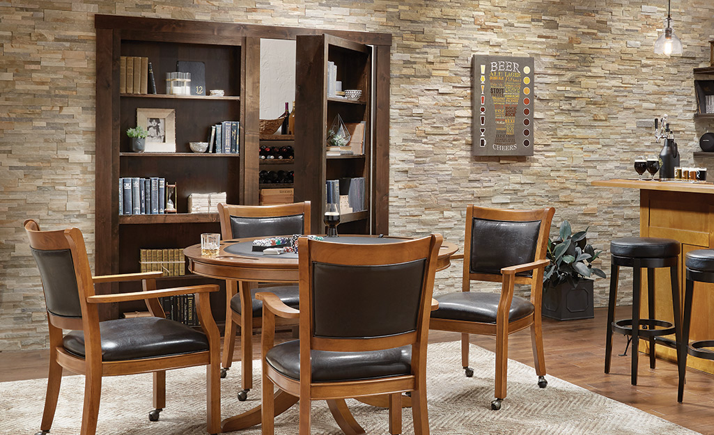 Bookcase doors in a dining area open slightly to show the closet they conceal. Bookcase doors in a dining area open slightly to show the closet they conceal.