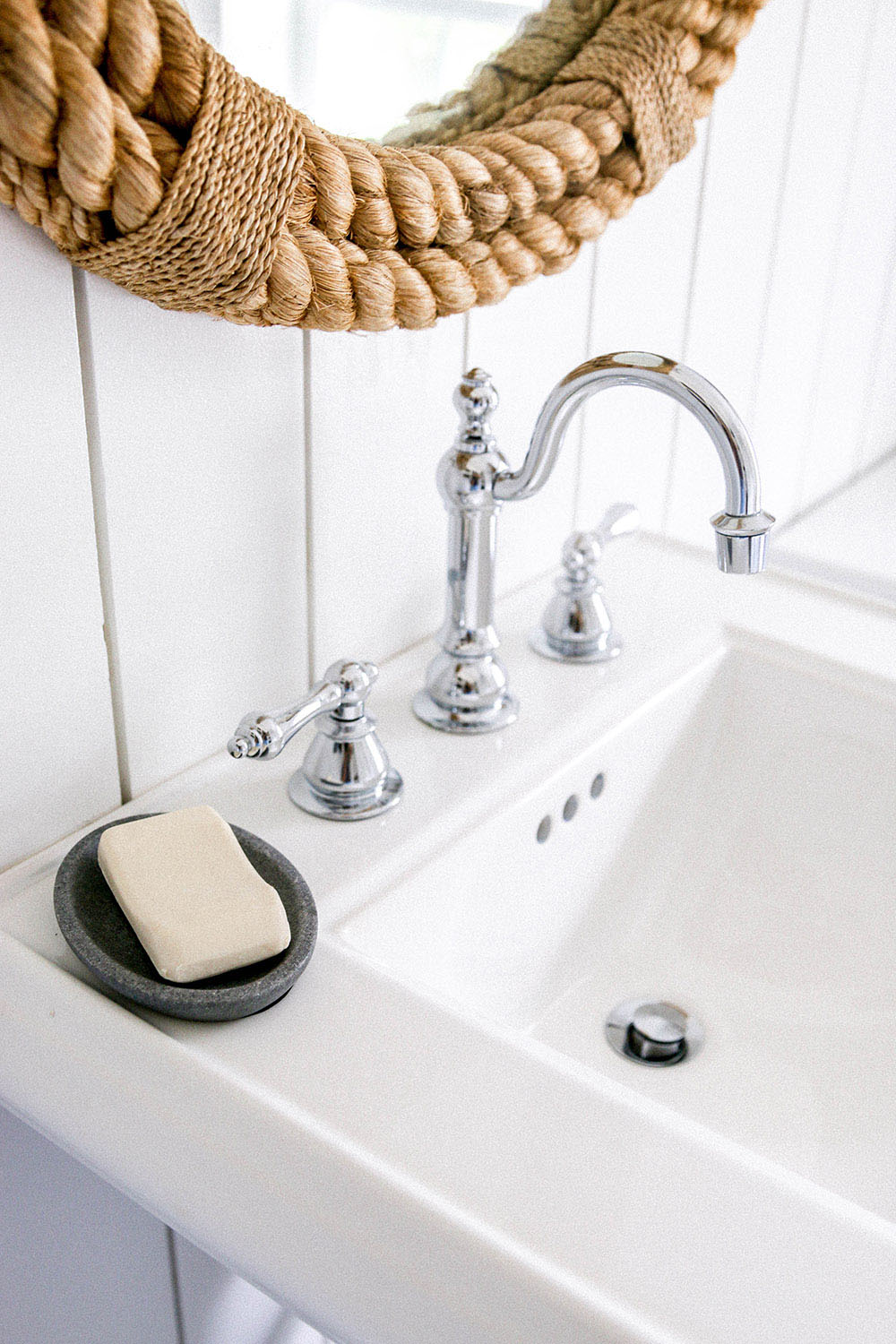 A pedestal sink with a chrome faucet.