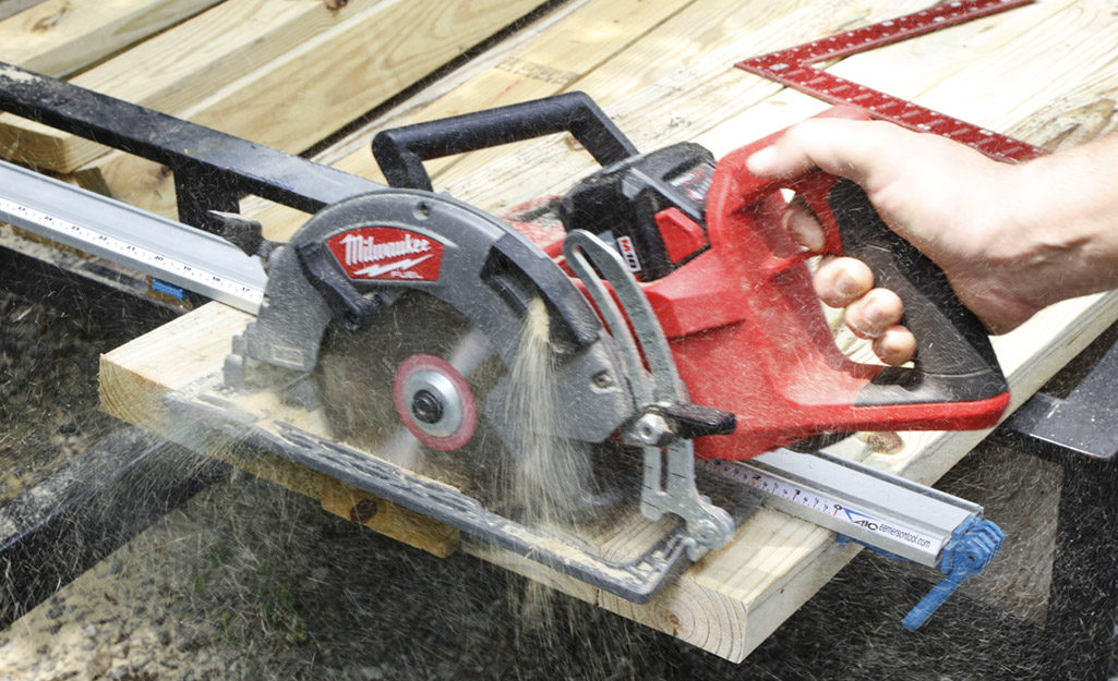 A person using a saw on wood.