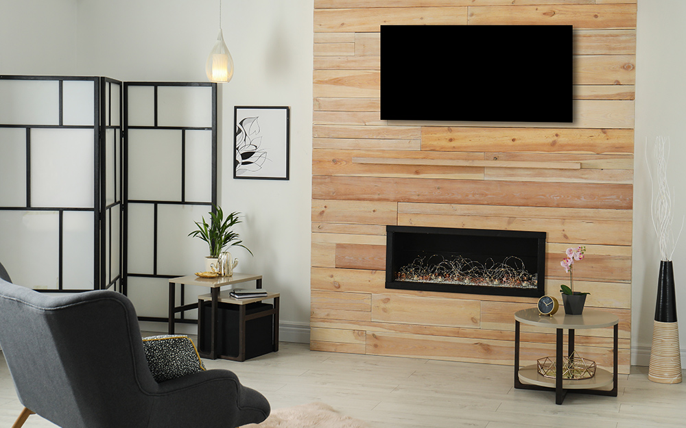 A living room with a folding screen and fire place.