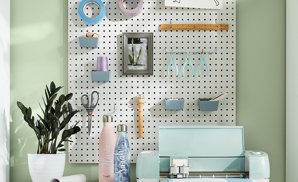 Crafting supplies stored on a pegboard and Circuit machine