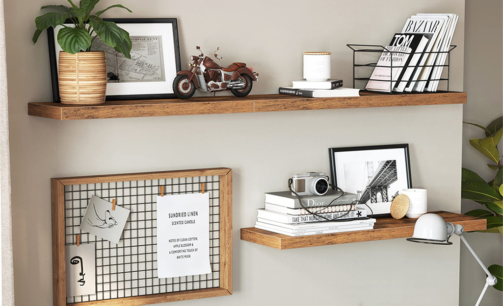 Floating shelves with books, photos and display board
